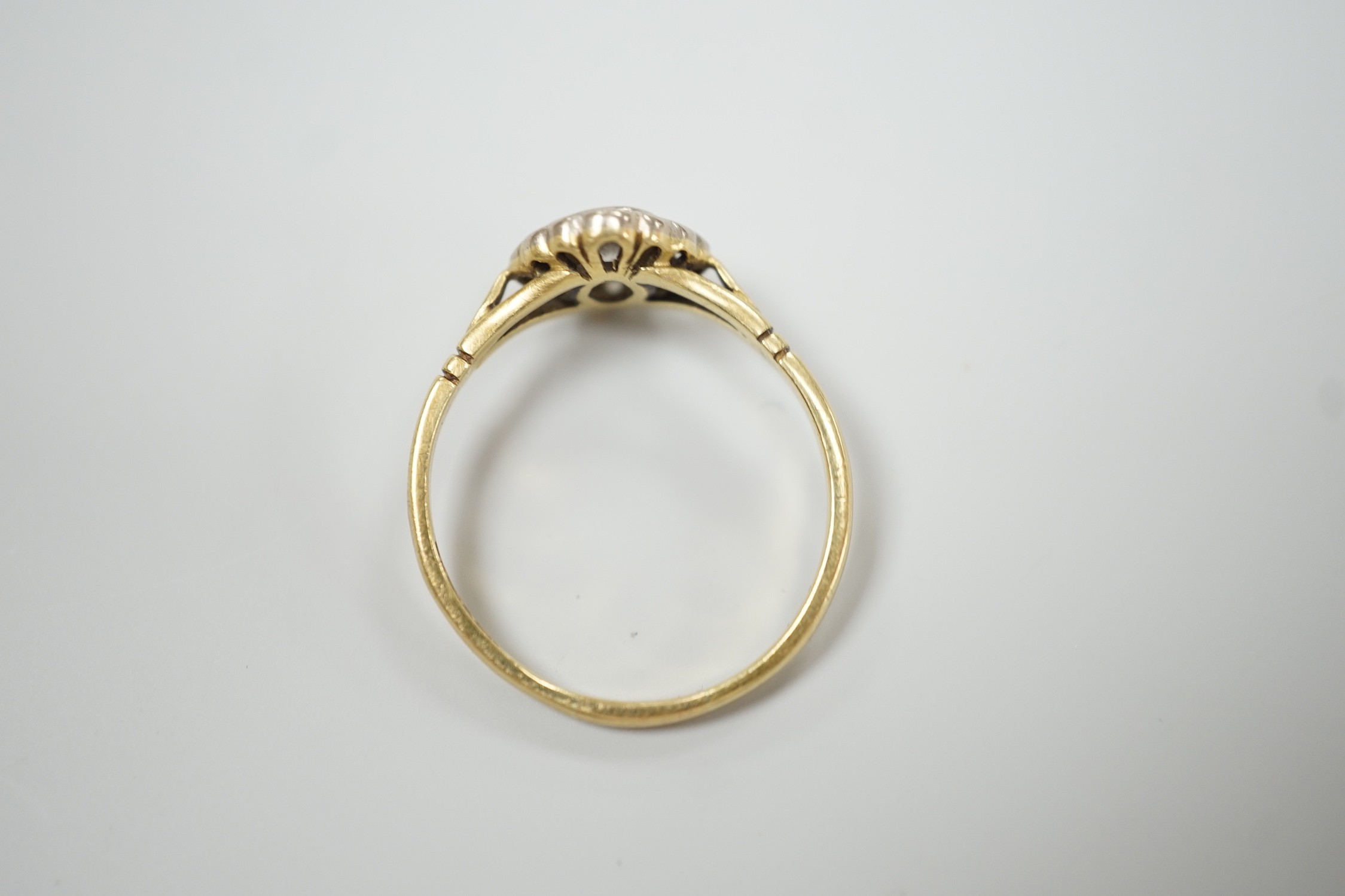 A modern 18ct gold and single stone diamond ring, with diamond set border, size S, gross weight 3.2 grams.